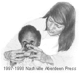 An Adult woman helping a young girl to drink from a cup